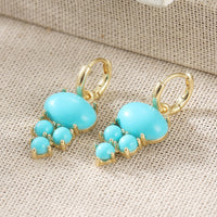 Gouden oorbellen met ovale turquoise en kraaltjes