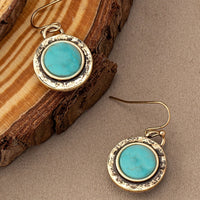 Goudkleurige vintage oorbellen met ronde turquoise