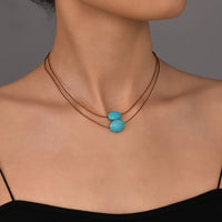 Bohemian ketting met turkooizen hanger en zilveren kwastjes