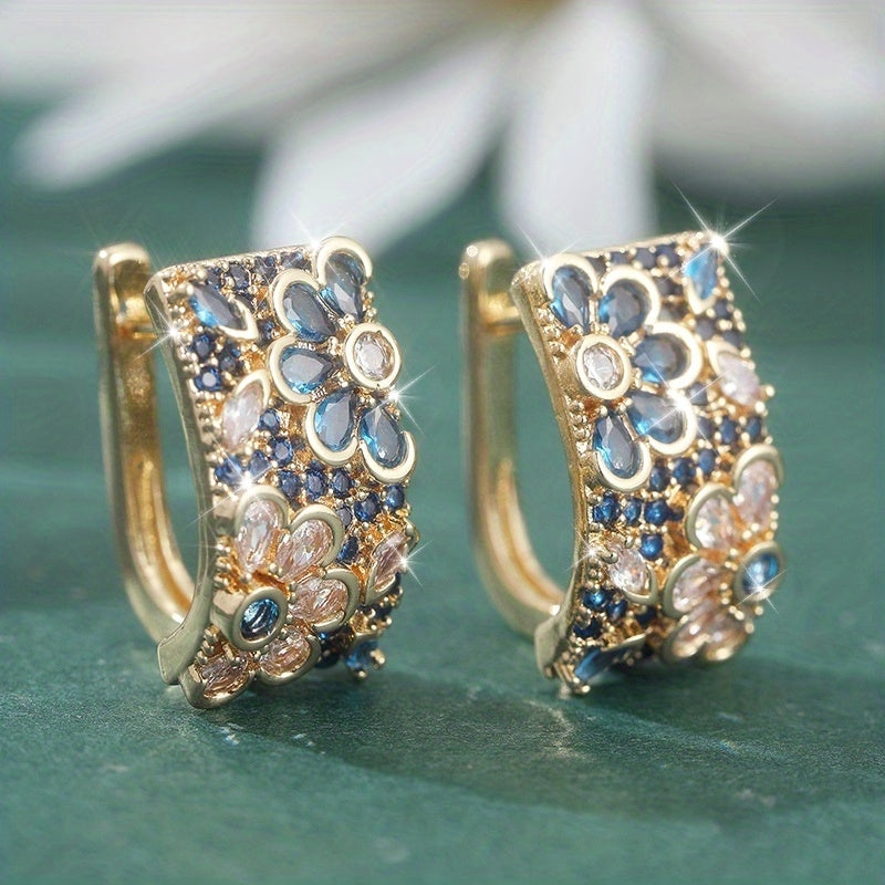 Gouden oorbellen met blauwe en roze bloemzirkonia