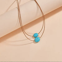Bohemian ketting met turkooizen hanger en zilveren kwastjes