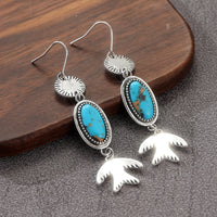 Zilveren oorbellen met ovale turquoise en vogelhanger