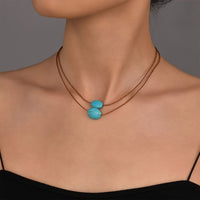 Bohemian ketting met turkooizen hanger en zilveren kwastjes