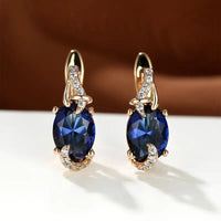 Zilveren ring met grote blauwe edelsteen en bladmotief