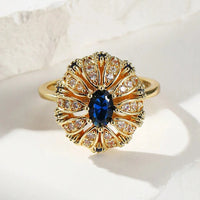 Gouden vintage ring met blauwe ovale steen en zirkonia