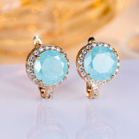 Gouden clip-oorbellen met ronde turquoise steen en zirkonia