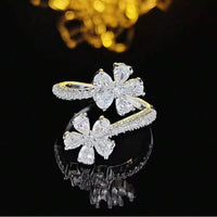 Gouden open ring met twee zirkonia bloemen