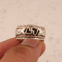 Zilveren spinner ring met hartjes en bloemen