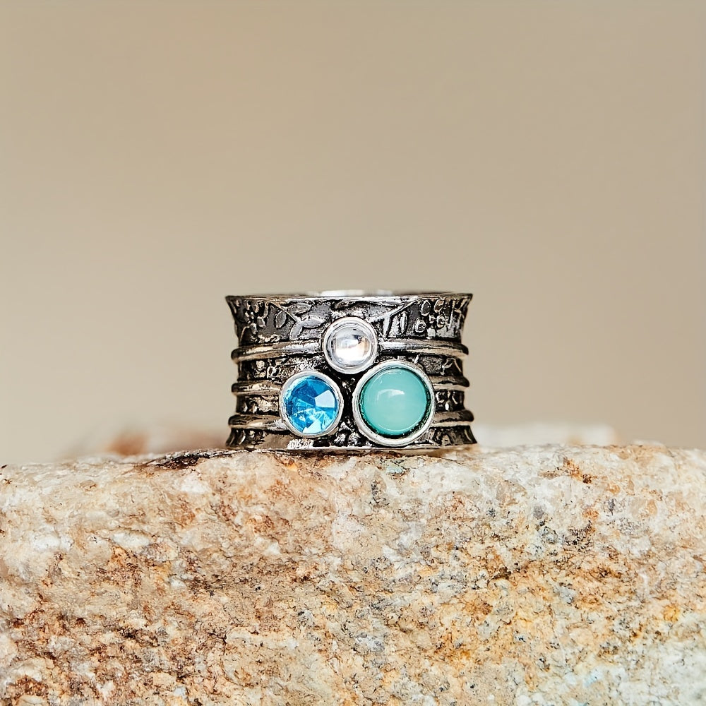 Zilveren spinner ring met blauwe edelstenen