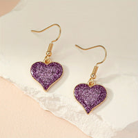 Gouden oorbellen met paars glitterhart