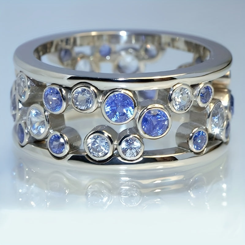 Brede zilveren ring met blauwe en witte zirkonia