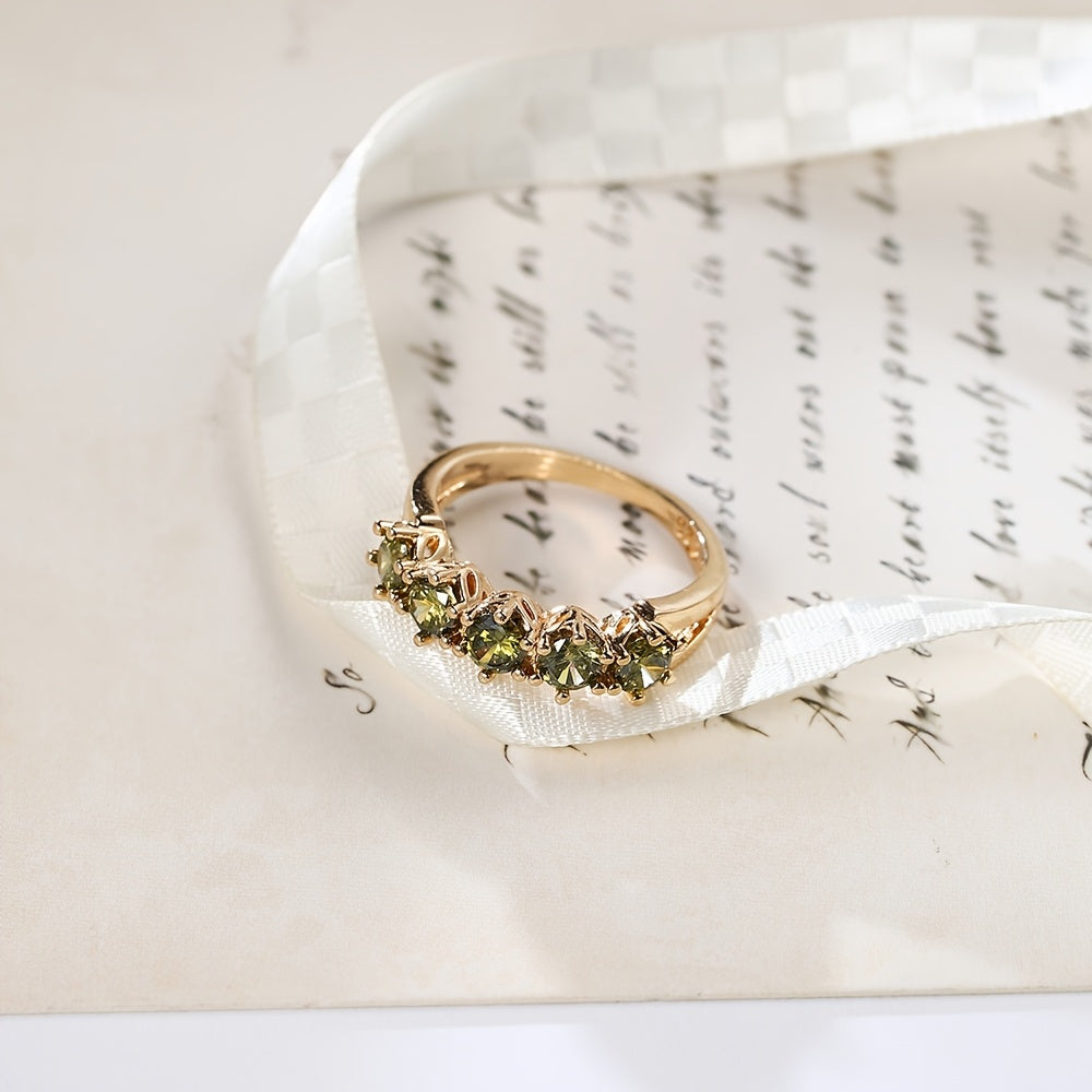 Gouden ring met vijf groene edelstenen