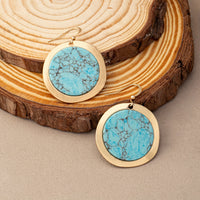 Zilveren oorbellen met ronde turquoise schijf