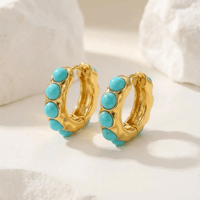 Gouden oorbellen met turquoise cabochons