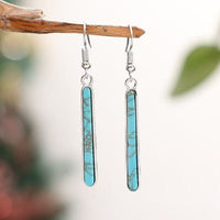 Zilveren oorbellen met langwerpige turquoise staaf