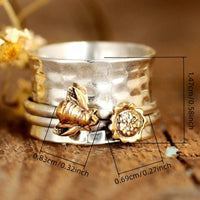 Zilveren spinner ring met gouden bij en bloem