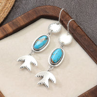 Zilveren oorbellen met ovale turquoise en vogelhanger