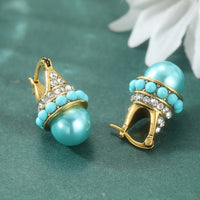 Vintage gouden oorbellen met turquoise parel