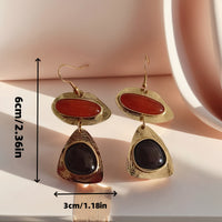 Gouden vintage oorbellen met rode en zwarte stenen