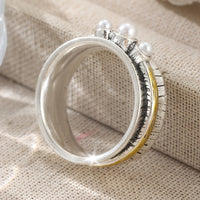 Zilveren ring met parels en goudkleurige spinner band