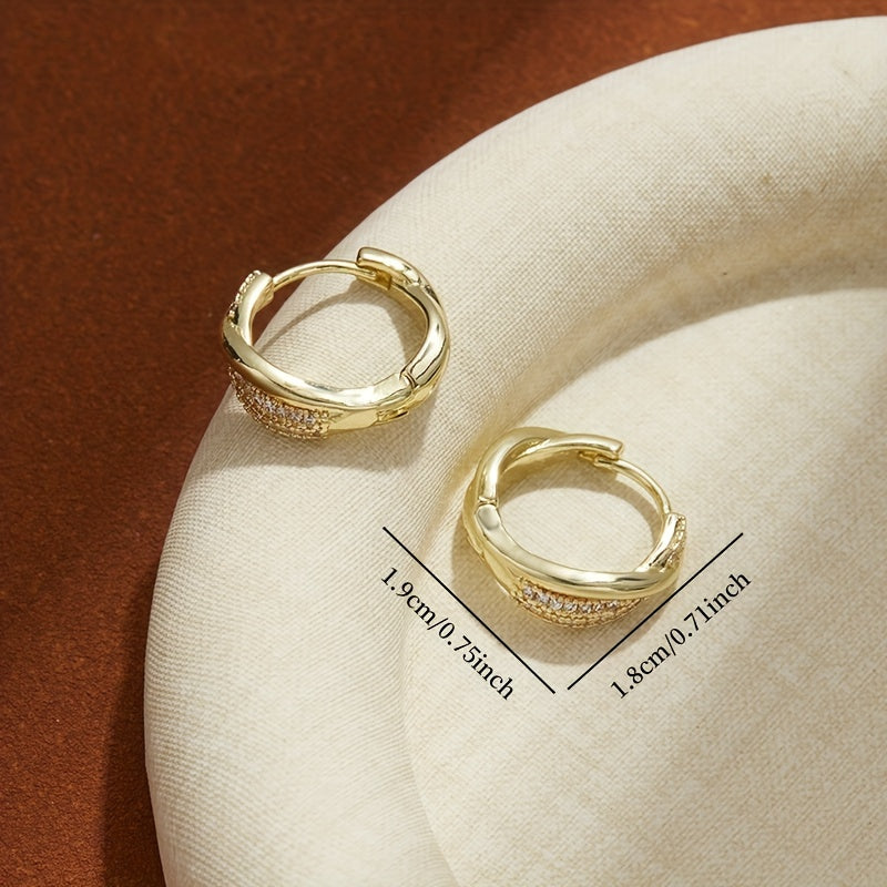 Gouden gedraaide oorbellen met pavé zirkonia