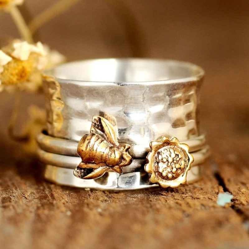 Zilveren spinner ring met gouden bij en bloem