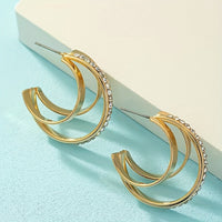 Gouden meerlaagse C-oorbellen met strass detail