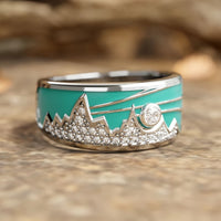 Zilveren ring met turquoise emaille berg-zonmotief en zirkonia