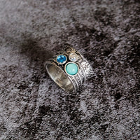 Zilveren spinner ring met blauwe edelstenen