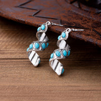 Zilveren oorbellen met spiraal en turquoise