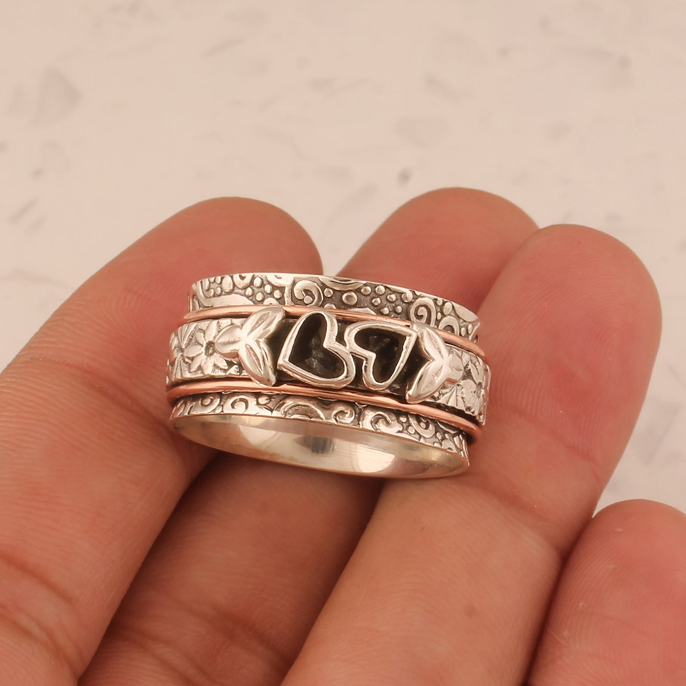 Zilveren spinner ring met hartjes en bloemen