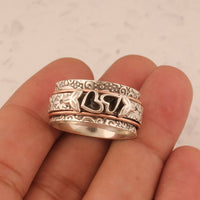 Zilveren spinner ring met hartjes en bloemen