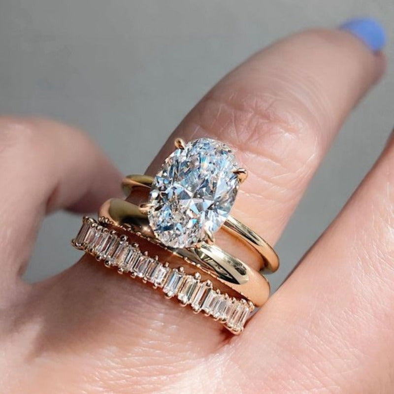 Gouden ring met ovale zirkonia en baguette band