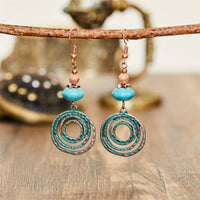 Bohemian oorbellen met roségoud spiraal en turquoise