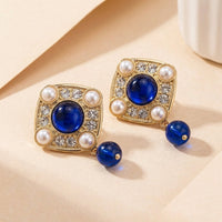 Gouden vintage oorbellen met blauwe steen en parels