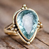 Gouden ring met peervormige lichtblauwe edelsteen