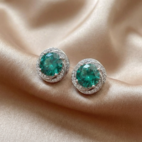 Zilveren oorbellen met blauwgroene edelsteen en halo