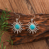 Gouden bohemian oorbellen met turquoise zon