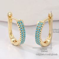 Gouden huggie-oorbellen met turquoise pavé