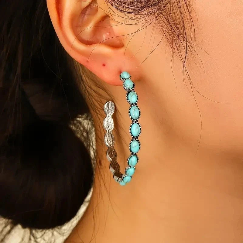 Zilveren oorbellen met ovale turquoise edelstenen