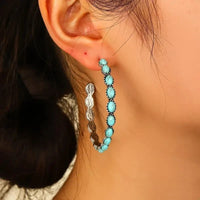 Zilveren oorbellen met ovale turquoise edelstenen