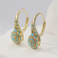 Gouden vintage oorbellen met turquoise rozet