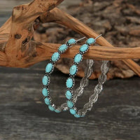 Zilveren oorbellen met ovale turquoise stenen