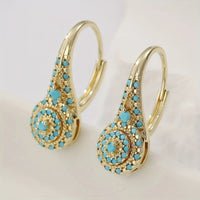 Gouden vintage oorbellen met turquoise rozet