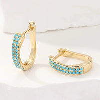 Gouden huggie-oorbellen met turquoise pavé