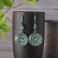 Bohemian oorbellen met mandala glasschijf en groene kralen