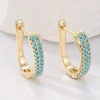 Gouden huggie-oorbellen met turquoise pavé