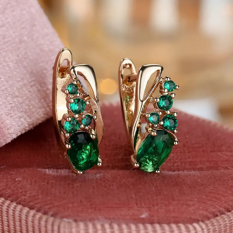 Gouden oorbellen met groene edelstenen