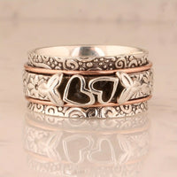Zilveren spinner ring met hartjes en bloemen