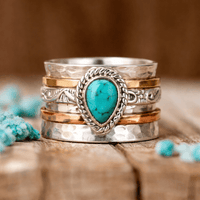 Zilveren spinner ring met druppelvormig turquoise